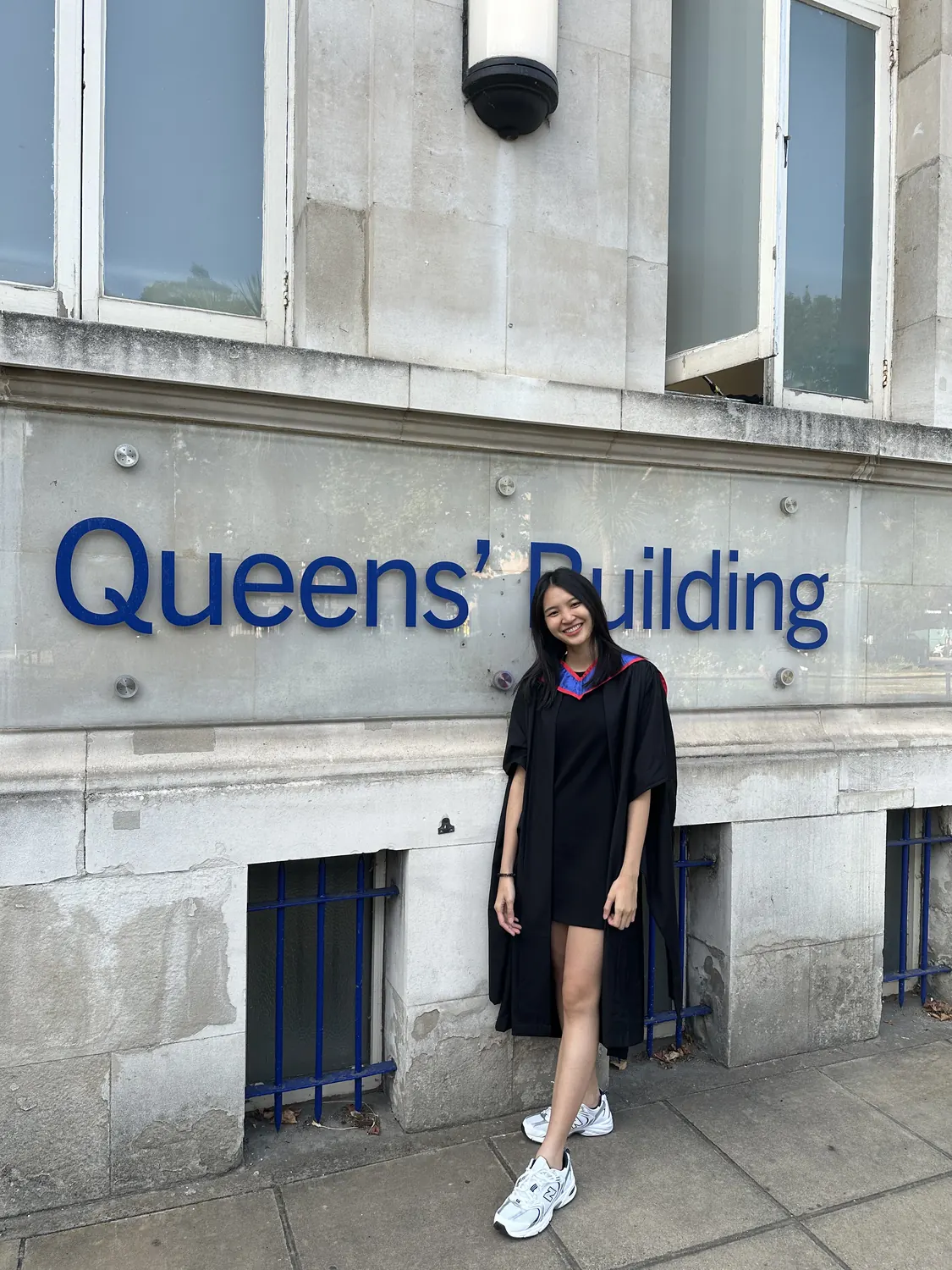 Graduation gown outside the Queens' Building, Queen Mary University of London